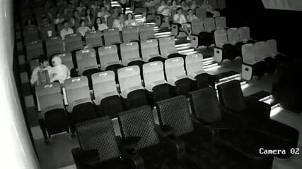 A couple having sex in front of everyone in a cinema hall