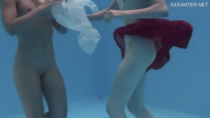 Girlfriends enjoy swimming naked together