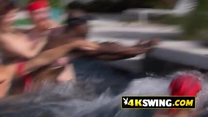 Partner exchange at a pool party kissing contest between hot swinger couples.