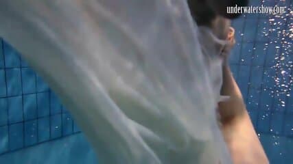 Dark haired teen Andrea in the pool